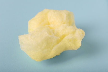 Sweet cotton candy on light blue background, closeupの写真素材