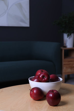 Red apples on side table in living room. Space for textの写真素材