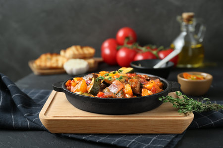 Dish with tasty ratatouille on black tableの写真素材