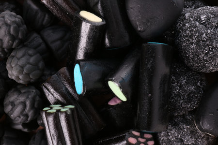 Many tasty liquorice candies as background, top viewの写真素材