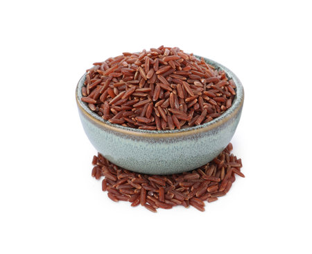 Bowl with raw red rice isolated on whiteの写真素材