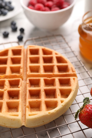 Tasty Belgian waffle with strawberry on table, closeupの写真素材