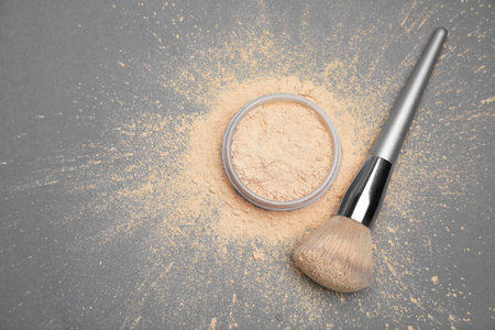 Loose face powder and makeup brush on gray background, flat layの写真素材