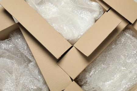 Many open cardboard boxes with popping wrap as background, top viewの写真素材