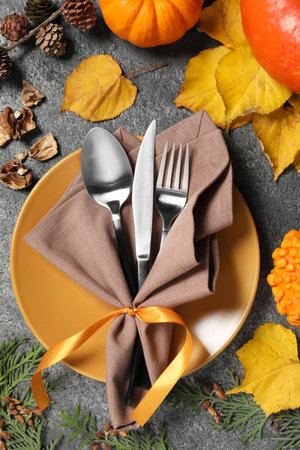 Happy Thanksgiving day. Beautiful table setting and autumn decoration on gray background, flat layの写真素材