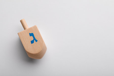 Wooden dreidel on white background, top view with space for text. Traditional Hanukkah gameの写真素材