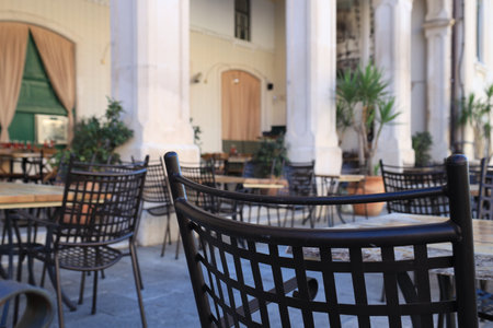 Outdoor cafe with stylish furniture and green plants, closeup. Space for textの写真素材