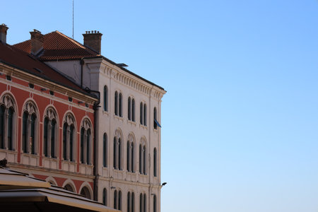 Exterior of buildings with arched windows against blue sky. Space for textの写真素材