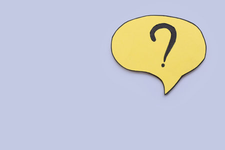 Paper speech bubble with question mark on light gray background, top view. Space for text