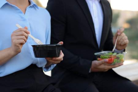 Business people having lunch together outdoors, closeupの写真素材