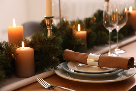 Luxury place setting with festive beautiful decor for Christmas dinner on wooden tableの写真素材