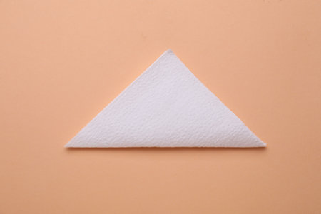 Clean paper tissue on beige background, top view