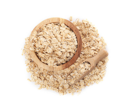 Wooden bowl and scoop with oatmeal isolated on white, top view