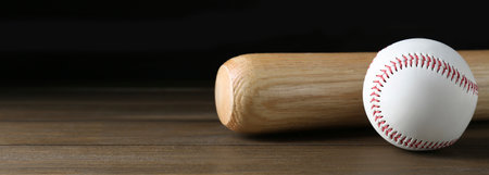 Baseball bat and ball on wooden table, space for text. Banner design