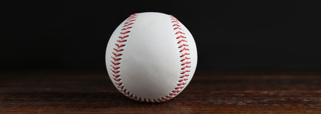 Baseball ball on wooden table, banner design
