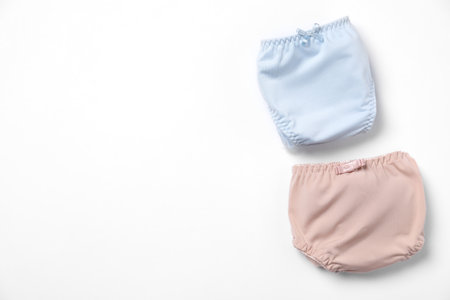 Stylish folded women's underwear on white background, flat lay. Space for text