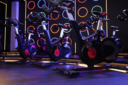 Many exercise bikes in fitness club. Indoor cycling class