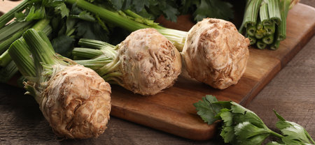 Fresh raw celery roots on wooden table, closeup. Banner designの写真素材