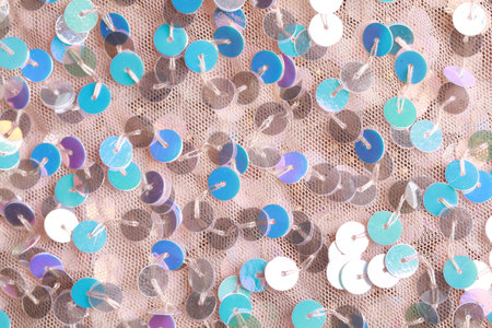 Beautiful pink fabric with shiny sequins as background, top view