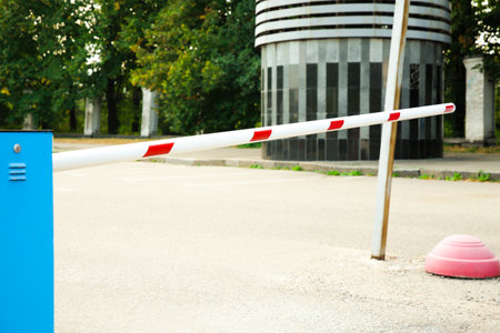 Closed boom barrier outdoors on sunny day
