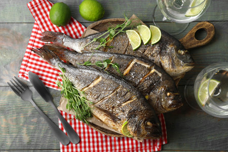 Delicious baked fish served on wooden rustic table. Seafood
