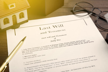 Last Will and Testament, house model, glasses and pen on table, closeupの写真素材