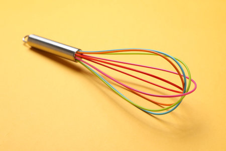 Bright whiskey on yellow background, closeup. Kitchen tool