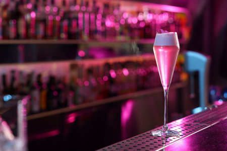 Fresh alcoholic cocktail on counter in bar. Space for text
