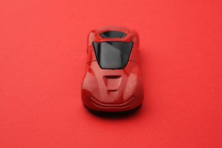 One bright car on red background. Children's toy
