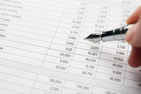 Accountant with fountain pen working with data, closeup
