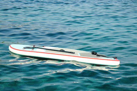 One SUP board with paddle on sea water