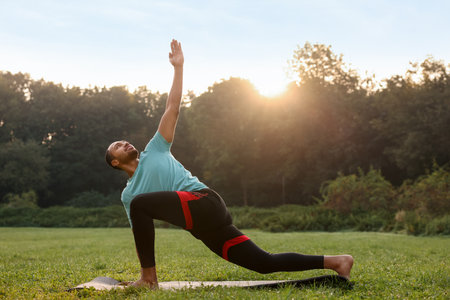 Man practicing yoga outdoors on sunny dayの写真素材