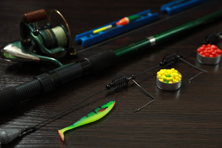 Fishing tackle on dark wooden background, closeup