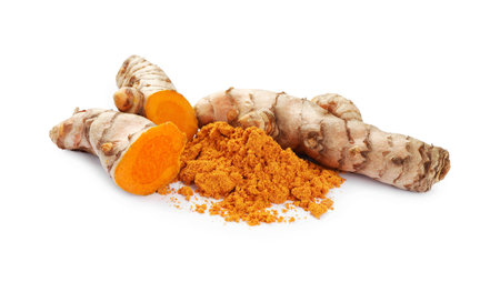 Aromatic turmeric powder and raw roots isolated on whiteの写真素材