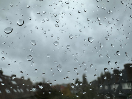 Window with water droplets on rainy day, closeupの写真素材