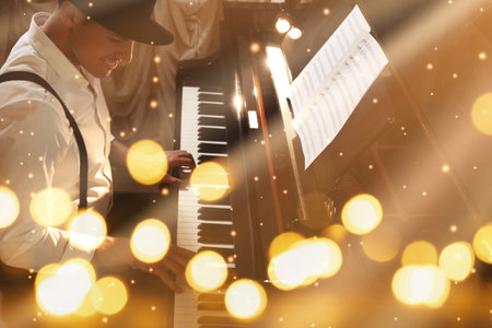 Christmas and New Year music. Man playing piano, bokeh effectの写真素材