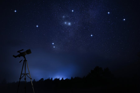 Astronomy. Viewing beautiful starry sky through telescope at nightの写真素材