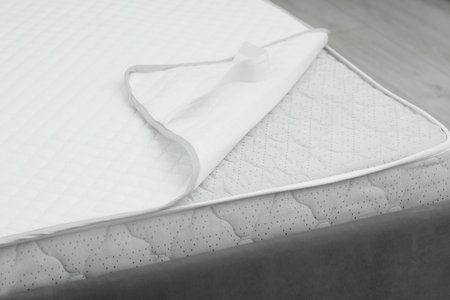 Soft mattress and protector on bed, closeupの写真素材