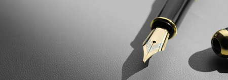 Fountain pen on gray table, closeup. Banner design with space for text