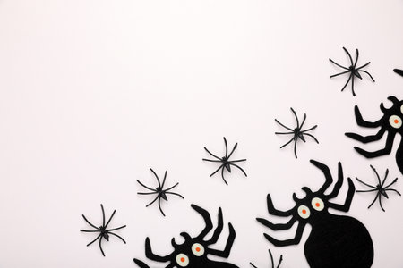 Many different spiders on white background, flat lay and space for text. Halloween celebration
