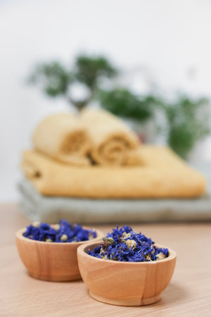 Bowls with dry flowers on light wooden table, space for text. Spaの写真素材
