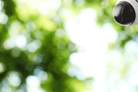 Modern security CCTV camera outdoors, space for text