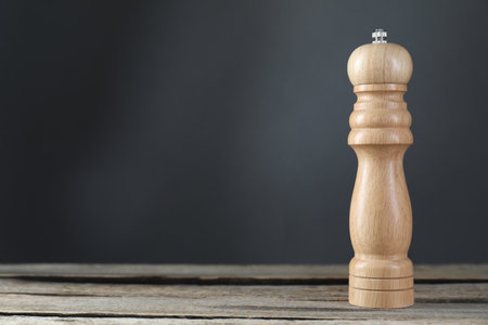 Salt or pepper shaker on wooden table, closeup. Space for textの写真素材