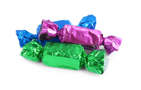 Tasty candies in colorful wrappers isolated on whiteの写真素材