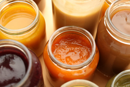 Jars with healthy baby food on table, closeupの写真素材