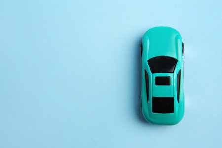 One bright car on light blue background, top view with space for text. Children's toyの写真素材