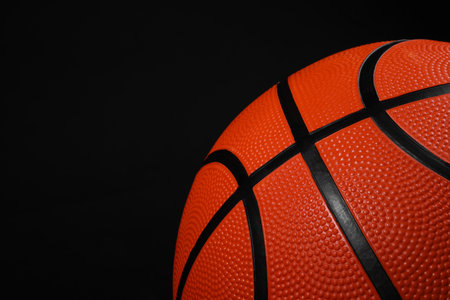 One basketball ball on black background, closeup. Space for textの写真素材