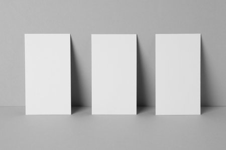 Blank business cards on light gray background. Mockup for designの写真素材
