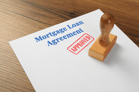 Mortgage loan agreement with Approved stamp on table, closeupの写真素材