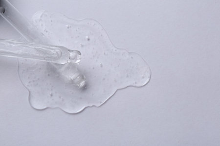 Pipettes with cosmetic serum on white background, top view. Space for textの写真素材